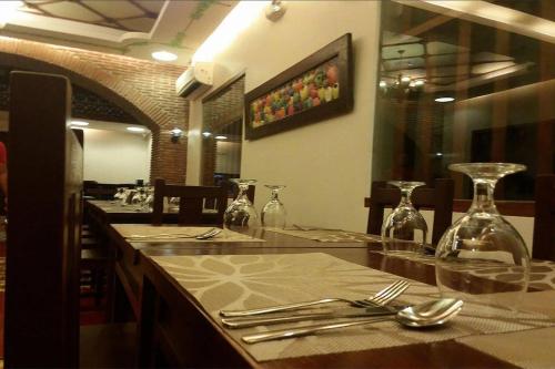 a restaurant with a table with utensils on a counter at NSCC Hotel Vigan in Vigan