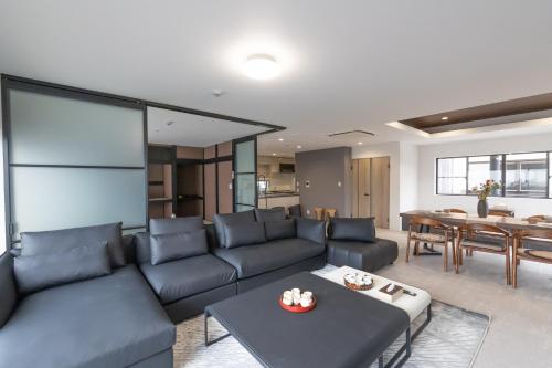 a living room with a blue couch and a table at 豊月荘 Toyotsuki in Osaka