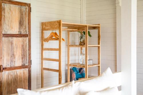 a room with a wooden book shelf next to a door at Mambo Hill Resort in Nusa Penida