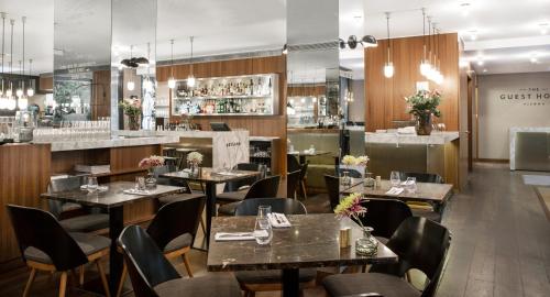 a restaurant with tables and chairs and a bar at The Guesthouse Vienna in Vienna
