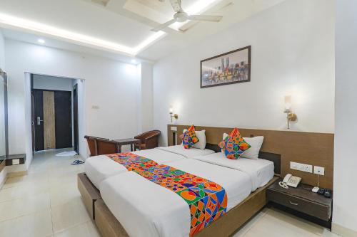 Un dormitorio con una cama grande con una manta de colores. en FabHotel Prime The Continental, en Lucknow