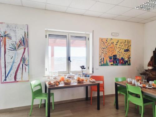 a dining room with a table with fruit on it at Agri B&B Terre Joniche in Isola Capo Rizzuto