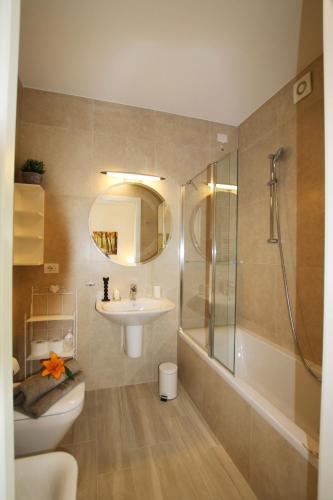 a bathroom with a sink and a shower and a toilet at Ikhaya Como - Acquaseria, San Siro by LoveComo in Acquaseria