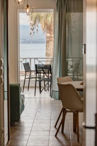 a living room with a view of the ocean at Seaside Apartments in Áyios Vasílios