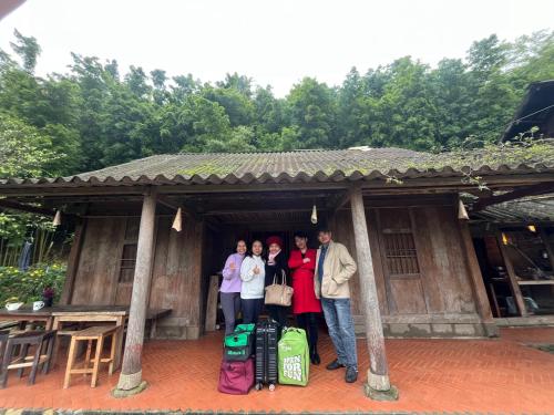 a group of people standing in a building with luggage at Sa Moc - La Maison House & Bungalow in Sa Pa