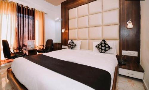 a bedroom with a large bed in a room at Mangal Residency Rooftop Pool in Udaipur