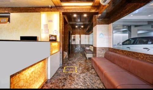 a lobby of a car dealership with a couch at Mangal Residency Rooftop Pool in Udaipur