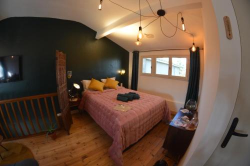 a bedroom with a bed and a window in it at Le Grenier Du Botaniste in Mauléon