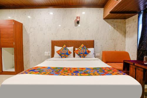 a bedroom with a bed and a desk in a room at FabExpress Yatri Inn in Turambhe