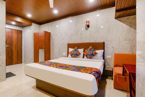 a bedroom with a large bed in a room at FabExpress Yatri Inn in Turambhe