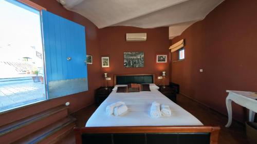 a bedroom with a bed with two towels on it at Hotel Utopía in Benalup Casas Viejas