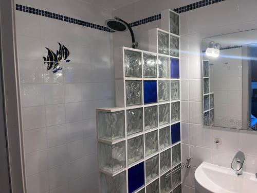 a bathroom with a sink and a mirror at Lucky Lemons - Boutique Houses Madeira (Studio) in Calheta
