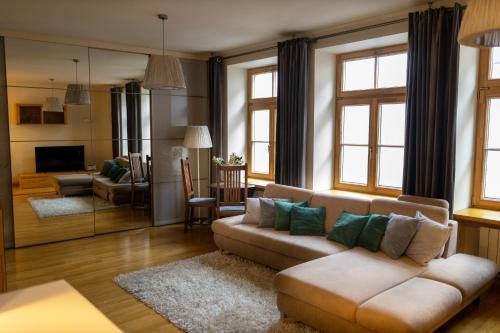 a large living room with a couch and a living room with at Old City Harmony Apartment in Riga