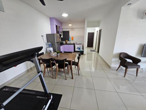 a kitchen and dining room with a table and chairs at A&H Homestay Seberang Jaya with Swimming Pool & 3 Bedroom AC in Permatang Janggus