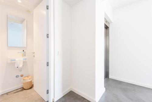 a white bathroom with a shower and a sink at Villa Nineten in Roca Llisa