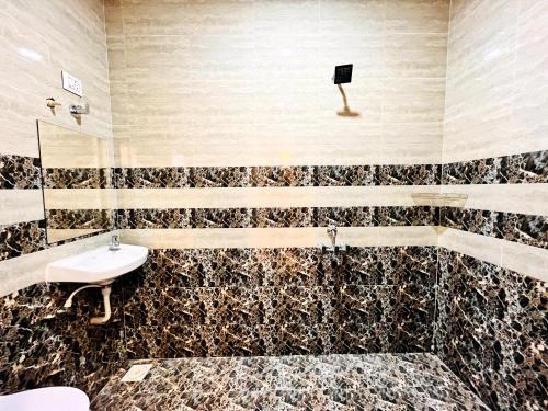 a bathroom with a sink and a mirror at Hotel Kutch Palace in Bhuj
