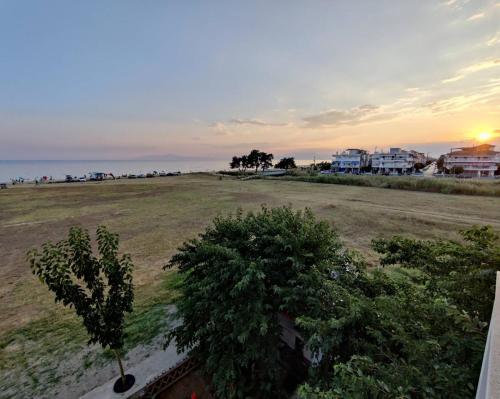a view of a field with trees and the ocean at See to Sea Apartments 2 in Paralia Dionysiou