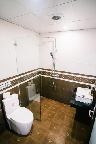 a bathroom with a toilet and a shower at Tamcoc Catalina Hotel in Ninh Binh
