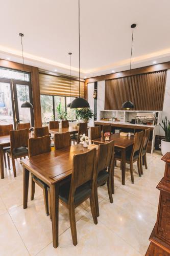 a dining room with wooden tables and chairs at Tamcoc Catalina Hotel in Ninh Binh