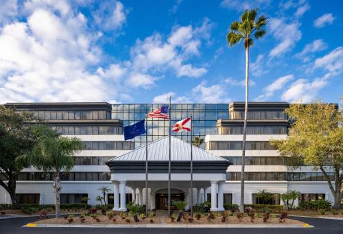 a building with two flags in front of it at Delta Hotels by Marriott Jacksonville Deerwood in Jacksonville