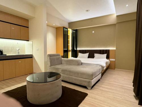 a hotel room with a bed and a couch at ARMERIA STAY 309 in Lucknow