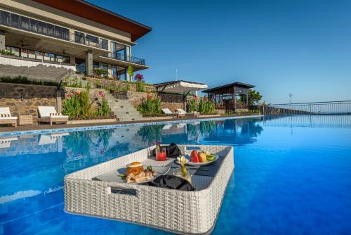 a boat in the water next to a swimming pool at THE most luxury 5BR villa in Lovina! Stunning Outlook! in Lovina