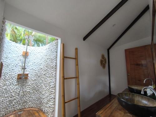a bathroom with a large window and a sink at U Story Resort in Siquijor