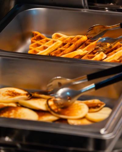 two trays of waffles and eating utensils at Ahola Thoddoo, Maldives in Thoddoo