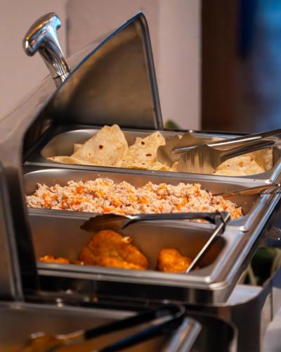 two trays of food on a buffet table at Ahola Thoddoo, Maldives in Thoddoo