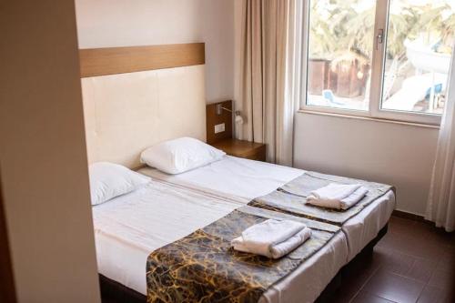 Ένα ή περισσότερα κρεβάτια σε δωμάτιο στο Akalia Suite Hotel & SPA