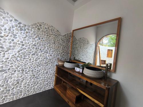 a bathroom with a mirror and a dresser with plates at U Story Resort in Siquijor