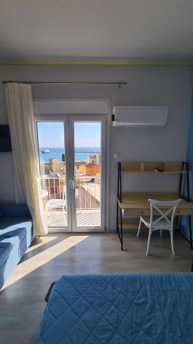 a bedroom with a bed and a view of the ocean at ΛΙΜΑΝΙ in Chios