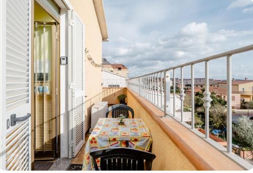 a balcony with a table and a view of the city at B&B Arcipelago in La Maddalena