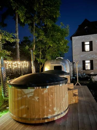 a wooden tub sitting on top of a wooden deck at BOHO HOUSE in Ustrzyki Dolne