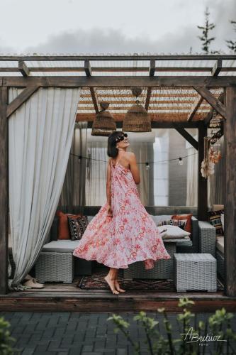 a woman in a dress standing on a couch at BOHO HOUSE in Ustrzyki Dolne