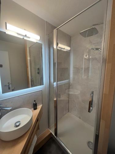 a bathroom with a shower and a sink at Logis - Hôtel de la Baie de Somme in Le Crotoy