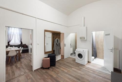 a living room with a washing machine and a kitchen at Prague - Karlin Apartments in Prague