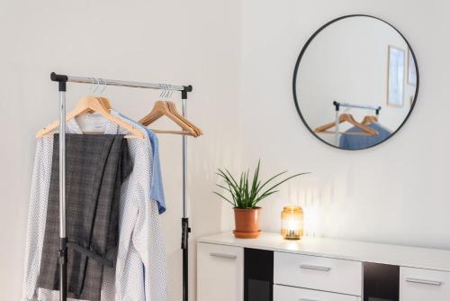 a dressing room with a mirror and a dresser at Prague - Karlin Apartments in Prague