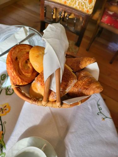 a basket of bread and pastries on a table at Vue Du Vallon in Bersac-sur-Rivalier