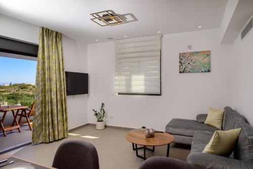 a living room with a couch and a table at Antheon Apartment 1 in Agios Nikolaos