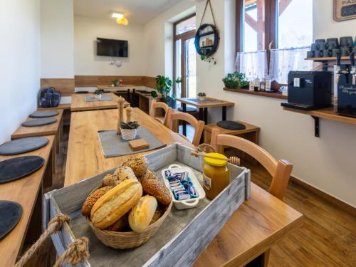 a bakery with a table with a basket of bread at Penzion Krumlovské rozcestí in Český Krumlov