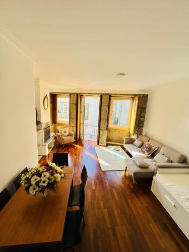 a living room with a table and a couch at Refúgio rooms in Viana do Castelo