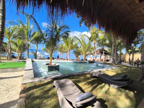a resort swimming pool with a bench and palm trees at U Story Resort in Siquijor