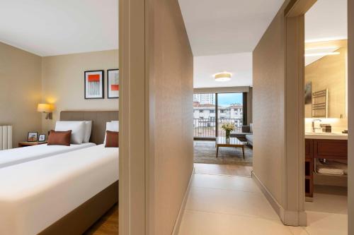 a hotel room with a large bed and a kitchen at Tzl Suites Hotel Nişantaşı in Istanbul