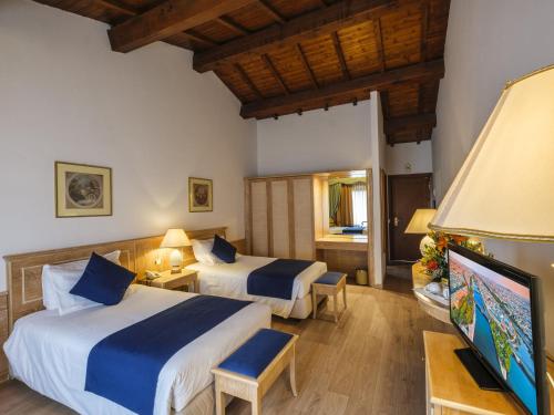 Postel nebo postele na pokoji v ubytování Hotel Orologio