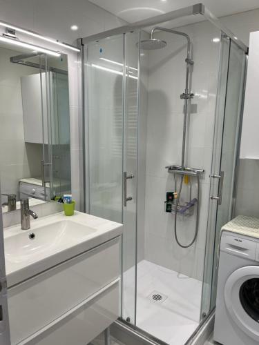 a bathroom with a shower and a sink and a toilet at Prestige Ocean Apartment - 50 m2 - 2 chambres in Lacanau