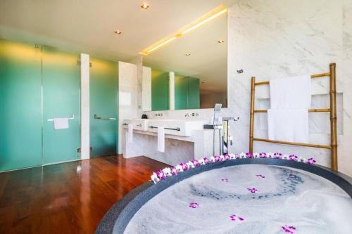 a bathroom with a tub with a sink and a mirror at EVA Beach sea view Four room villa in Ban Saiyuan (1)