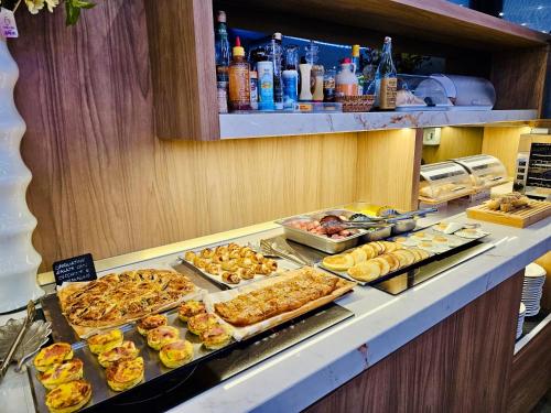 a buffet line with many different types of food at Canova Hotel in Milan