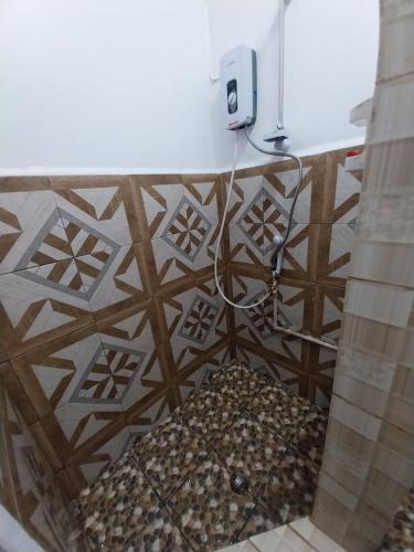 a bathroom with a counter with a towel dispenser at Chands Homestay Apartment in Lautoka
