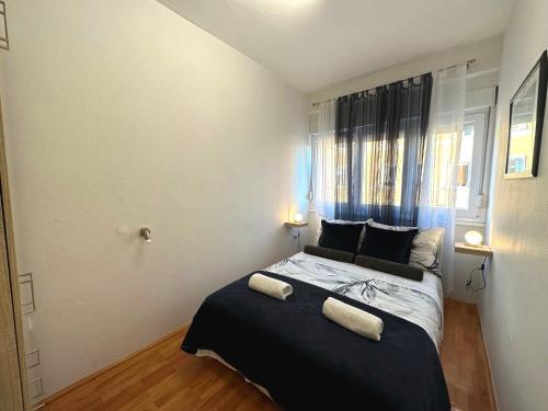 a bedroom with a bed with two towels on it at Spacious 3BDR App in Center "Sunny Bayside" in Zadar
